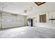 Spacious garage interior with a white door and concrete floors at 1313 Oakwood Trl, Indianapolis, IN 46260