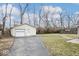 Detached garage with a driveway and lawn in the backyard at 1313 Oakwood Trl, Indianapolis, IN 46260
