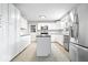 Modern kitchen featuring stainless steel appliances, white cabinets, an island and tile floors at 1313 Oakwood Trl, Indianapolis, IN 46260