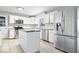 Modern kitchen featuring stainless steel appliances, white cabinets, and an island at 1313 Oakwood Trl, Indianapolis, IN 46260