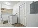 The laundry room is equipped with a washer, dryer, and shelving at 1313 Oakwood Trl, Indianapolis, IN 46260