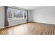 Bright living room with large window, hardwood floors, and neutral paint at 1313 Oakwood Trl, Indianapolis, IN 46260