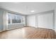 Bright living room featuring hardwood floors and a double-door closet at 1313 Oakwood Trl, Indianapolis, IN 46260