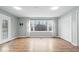 Spacious living room features hardwood floors, bright windows, and ample closet space at 1313 Oakwood Trl, Indianapolis, IN 46260