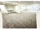Spacious carpeted basement area with neutral walls and built in shelving at 14596 Toponas Pl, Fishers, IN 46040