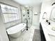 A well-appointed bathroom with white soaking tub, glass shower, and sleek vanity at 14596 Toponas Pl, Fishers, IN 46040