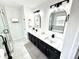 Modern bathroom featuring double sinks, framed mirrors, and glass enclosed shower with pristine finishes at 14596 Toponas Pl, Fishers, IN 46040