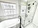 Bathroom with a standalone tub, sleek black finishes, and frameless glass shower with decorative wall tile at 14596 Toponas Pl, Fishers, IN 46040