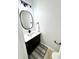 Small bathroom with a dark vanity, oval mirror, modern lighting, and black accents at 14596 Toponas Pl, Fishers, IN 46040