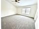 Spacious bedroom with a neutral palette, gray carpet, vaulted ceiling and large window for natural light at 14596 Toponas Pl, Fishers, IN 46040