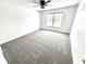 A cozy bedroom featuring neutral carpet, a ceiling fan, and a bright window at 14596 Toponas Pl, Fishers, IN 46040