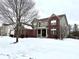 Side view of a brick home with a partially covered porch and snow in the yard at 14596 Toponas Pl, Fishers, IN 46040