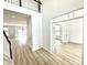 Spacious foyer with wood floors, staircase with a black handrail, and an open layout at 14596 Toponas Pl, Fishers, IN 46040