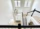 Open foyer with high ceilings, pendant lighting, and staircase with decorative stair runner at 14596 Toponas Pl, Fishers, IN 46040