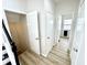 Hallway with multiple white doors and wood-look floors at 14596 Toponas Pl, Fishers, IN 46040