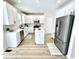 Bright kitchen featuring white cabinets, stainless steel appliances, and a center island with a marble countertop at 14596 Toponas Pl, Fishers, IN 46040