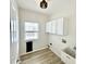 Laundry room featuring white cabinets, a utility sink, and wood-look floors at 14596 Toponas Pl, Fishers, IN 46040