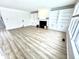 Cozy living room featuring a fireplace with built-in shelving and large window that provides ample natural light at 14596 Toponas Pl, Fishers, IN 46040