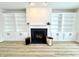 Living room featuring a charming fireplace with built-in shelving, perfect for creating a warm and inviting atmosphere at 14596 Toponas Pl, Fishers, IN 46040