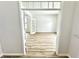 Bright room with wood floors, white walls, french doors, and a view through the doorway at 14596 Toponas Pl, Fishers, IN 46040