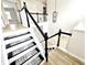 Bright staircase with white railings, black accents, and patterned stair treads at 14596 Toponas Pl, Fishers, IN 46040