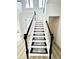 Modern staircase with black handrails and patterned stair runners at 14596 Toponas Pl, Fishers, IN 46040