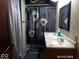Bathroom with floral shower curtain, double sink vanity, and a framed mirror at 1524 S K St, Elwood, IN 46036