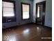 Bedroom with hardwood floors, dual windows, offering a bright and adaptable space, waiting for decor at 1524 S K St, Elwood, IN 46036