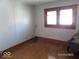 Bedroom features hardwood floors, a window, and baseboard trim at 1524 S K St, Elwood, IN 46036