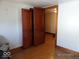 Bedroom featuring hardwood floors and a set of wooden doors at 1524 S K St, Elwood, IN 46036