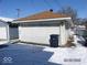 Detached garage with a wide door, providing convenient parking and storage space, set in winter at 1524 S K St, Elwood, IN 46036