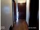 Hallway features wood flooring and doors with dark trim at 1524 S K St, Elwood, IN 46036