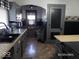 A kitchen featuring gray cabinets, gray walls, and a unique dining nook with black and white checkered curtains at 1524 S K St, Elwood, IN 46036