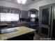 Kitchen featuring a stone countertop island and gray cabinetry at 1524 S K St, Elwood, IN 46036