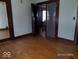 Living room featuring hardwood floors, spacious layout, and lots of light with original doors at 1524 S K St, Elwood, IN 46036