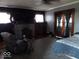 This living room features a gray accent wall, a fireplace, a ceiling fan, and a bedroom area at 1524 S K St, Elwood, IN 46036