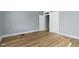 Spacious bedroom featuring neutral walls, wood-look flooring, white trim, and natural light from one window at 17 Parkview Ave, Indianapolis, IN 46201