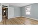 Spacious bedroom featuring neutral walls, wood-look flooring, white trim, and natural light from one window at 17 Parkview Ave, Indianapolis, IN 46201