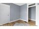 Bedroom with neutral walls, white trim, wood-look flooring, and two white doors at 17 Parkview Ave, Indianapolis, IN 46201