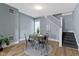 Dining room with hardwood floors, modern decor, and staircase at 17 Parkview Ave, Indianapolis, IN 46201