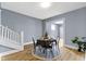 The dining room includes wood floors, blue walls, stylish furnishing, and natural light from an adjacent room at 17 Parkview Ave, Indianapolis, IN 46201