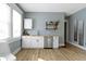 The kitchen includes new appliances, stylish hardware, decor shelving and white cabinets for ample storage at 17 Parkview Ave, Indianapolis, IN 46201