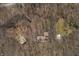 Aerial view of a wooded property featuring multiple structures, driveways, and mature trees at 1828 W 750 S, Trafalgar, IN 46181