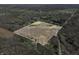 Aerial shot of the outlined acreage displaying a blend of wooded sections, open fields, and a tranquil pond at 1828 W 750 S, Trafalgar, IN 46181
