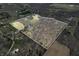 Overhead view of property outlined in white, featuring a combination of woodlands, open land, and a small pond at 1828 W 750 S, Trafalgar, IN 46181