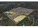 An aerial shot showcases a vast, outlined property with a mix of trees, open fields, and a serene pond at 1828 W 750 S, Trafalgar, IN 46181