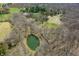 Bird's eye view of a tranquil pond, encircled by trees, adding a natural element to the property at 1828 W 750 S, Trafalgar, IN 46181