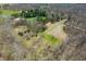 Expansive aerial view of wooded property with fields, a pond, a barn and residences in the distance at 1828 W 750 S, Trafalgar, IN 46181