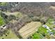 The aerial view captures a parcel with a small pond bordered by bare trees and a cleared, cultivated field at 1828 W 750 S, Trafalgar, IN 46181