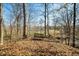 Wooded backyard with bench, perfect for nature lovers wanting a serene, quiet area to contemplate outdoors at 1828 W 750 S, Trafalgar, IN 46181